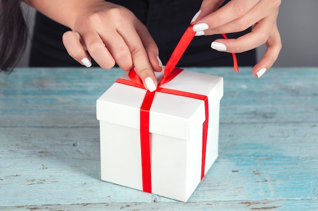 Woman hands wrapping present