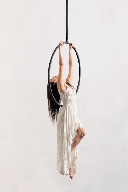 Woman hanging on aerial hoop