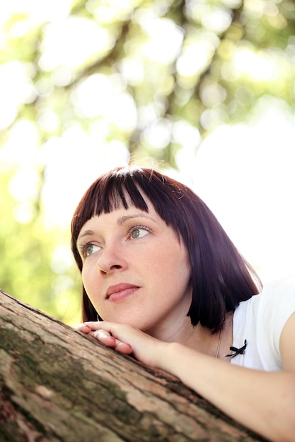 Woman hanging near a tree