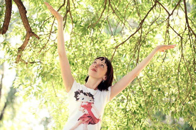 Woman hanging near a tree