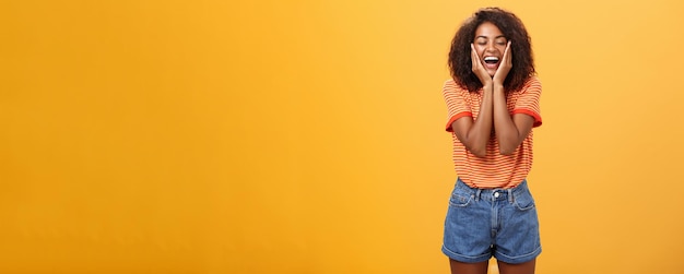 Woman happy and delighted with great result after curing acne with skincare products touching cheeks