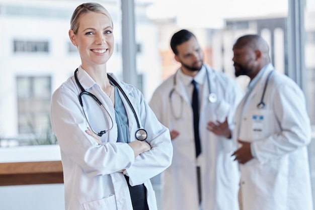 Photo woman happy and portrait of a doctor with arms crossed in a hospital for medical service smile pride and a female nurse or surgeon with confidence while working at a clinic and leadership