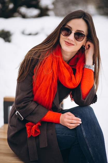 Woman happy in red scarf in winter outside