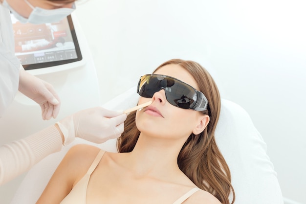 Woman has a laser epilation and cosmetology procedure