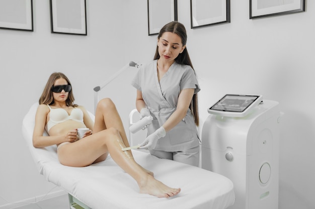 Woman has a laser epilation and cosmetology procedure