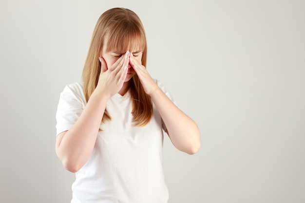 Woman has nose pain on a white background