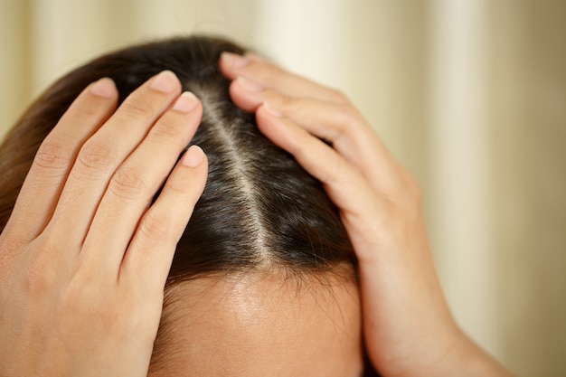 a woman has problems with hair and scalp