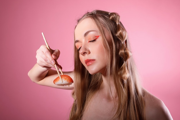 Woman has sushi with salmon and it tastes good