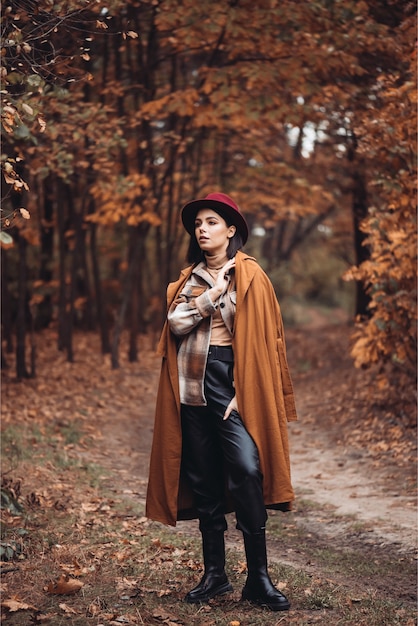 Woman in a hat and coat in the woods