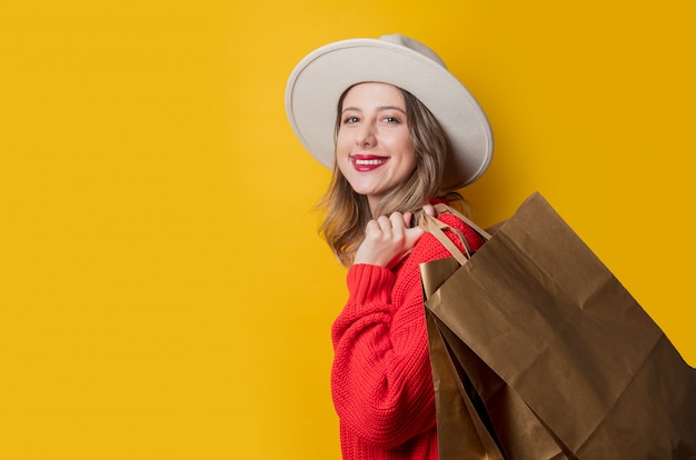 Woman in hat and shopping bags