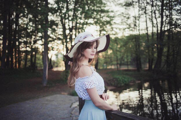 Woman in a hat in a spring park