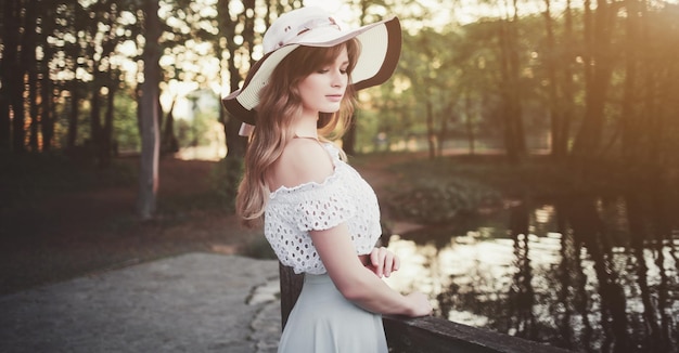 Woman in a hat in a spring park