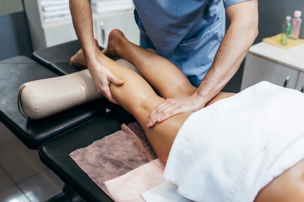 Woman having anticellulite foot massage