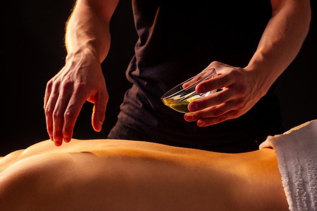 Woman having back therapy yoga massaging in gym spa panchakarma .