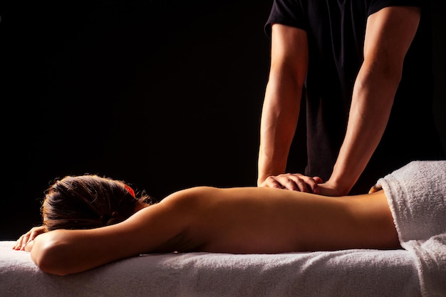 Photo woman having back therapy yoga massaging in gym spa.