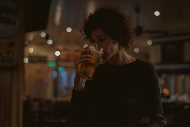 Woman having a beer at a bar