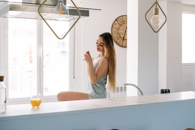 Woman having breakfast at home