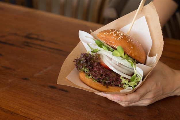 Woman having Burger on  lunch time