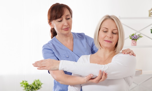 Woman having chiropractic back adjustment
