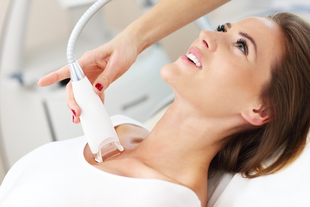 woman having cleavage treatment in beauty salon