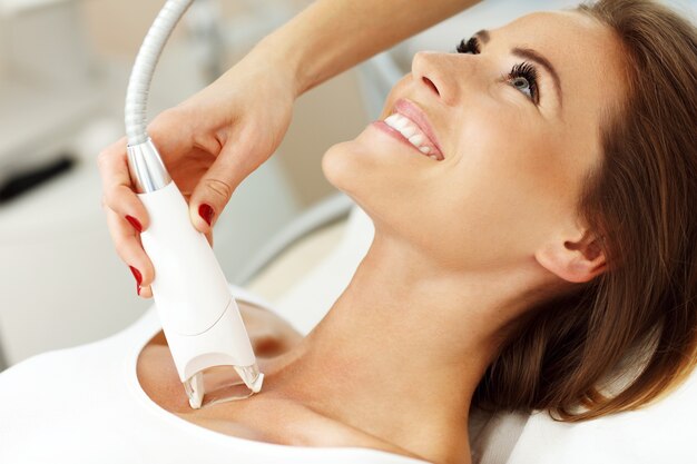 woman having cleavage treatment in beauty salon