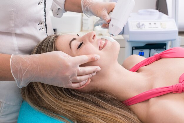 Woman having a facial massage and peeling in beauty salon