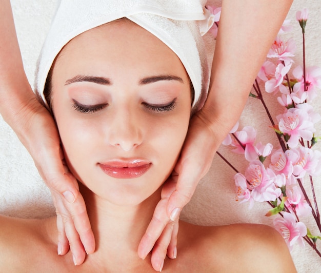 woman having facial massage at salon