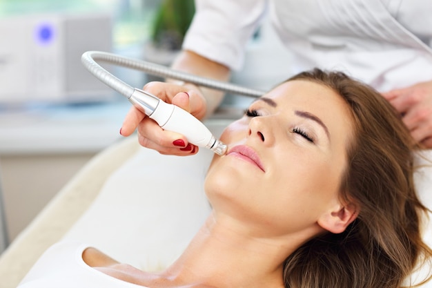 woman having facial treatment in beauty salon