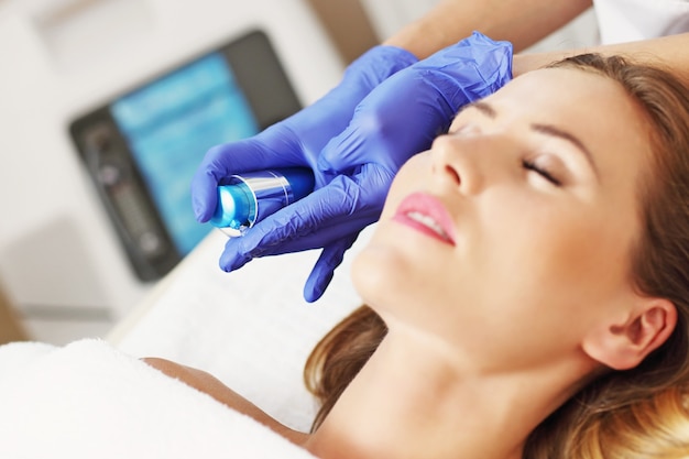 woman having facial treatment in beauty salon