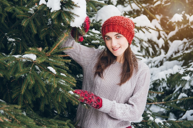 Woman having fun in winter forest 