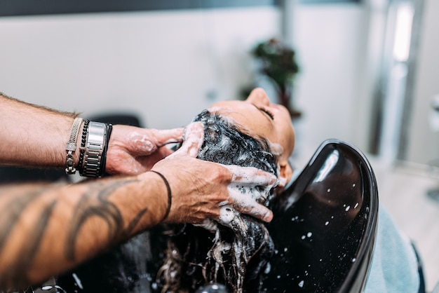 Woman having her hair washed at a professional hair salon.
