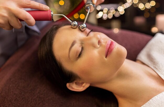 woman having hydradermie facial treatment in spa