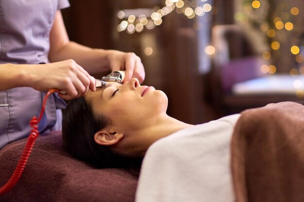 woman having hydradermie facial treatment in spa