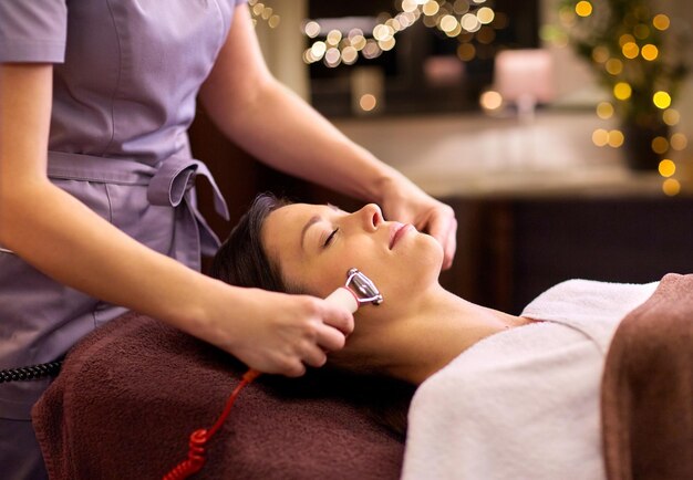 woman having hydradermie facial treatment in spa