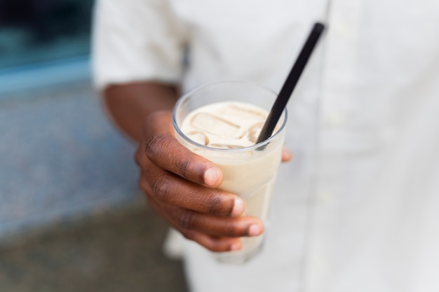 Woman having an iced coffee break outside