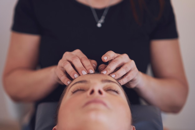 Woman having japan style face massage in salon