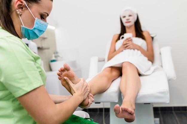 Woman having pedicure treatment in a modern beauty salon.