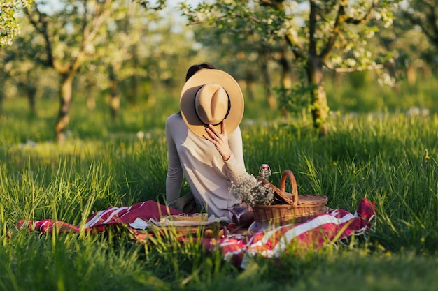 woman having picnic on sunny spring day