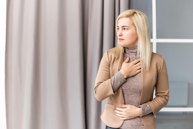 Woman having stomach ache at home.