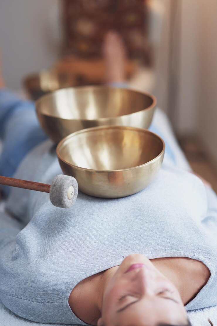 Woman having a Tibetan sound bowl massage