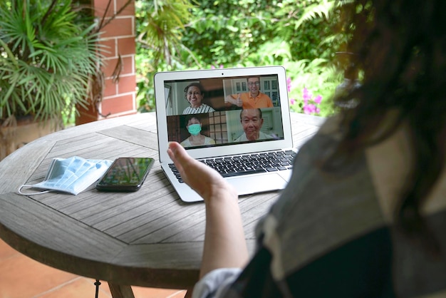 Woman having video call and chat with family via computer\
laptop at home