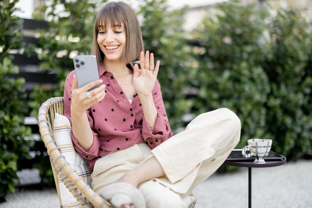 Woman having video call on phone at backyard