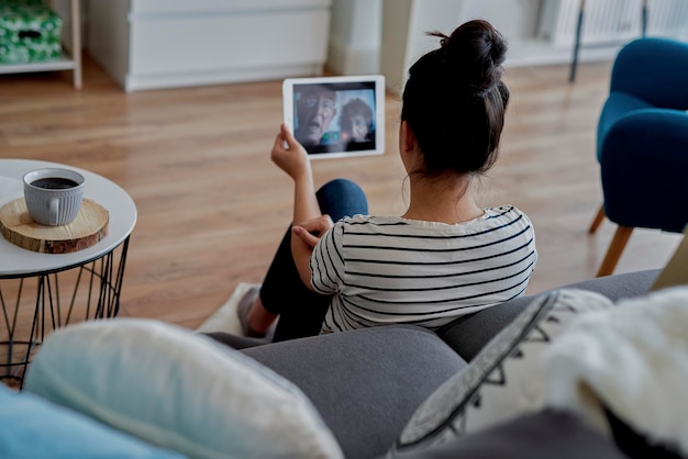 woman having a video conference with grandparents on the tablet