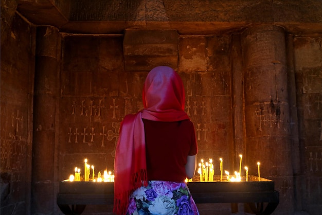 Woman in headcovering praying in the Orthodox church