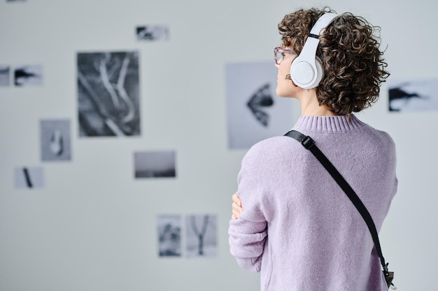 Woman in headphones listening to guide