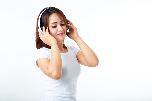 Woman headphones listening music on white