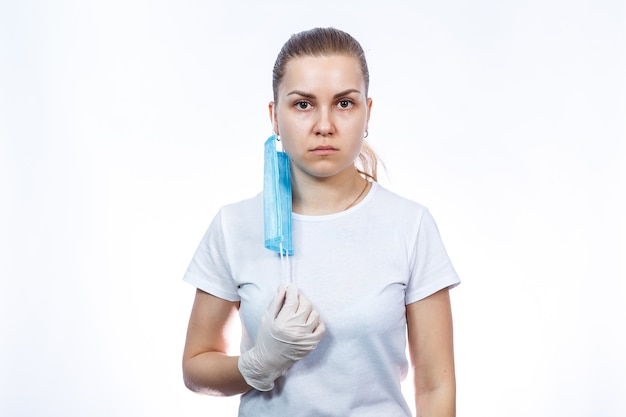 Woman health worker in protective medical surgical mask against the virus. Isolated on white background