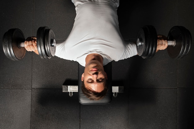 Woman helping man at gym