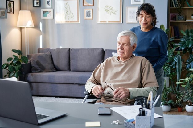 Woman helping senior man at home