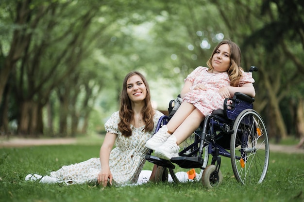 Woman and her disabled friend having picnic at park